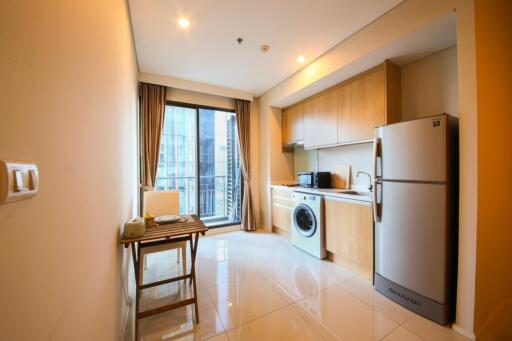 Modern kitchen with dining area and laundry integrated