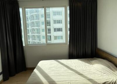 Modern bedroom with large windows and natural light