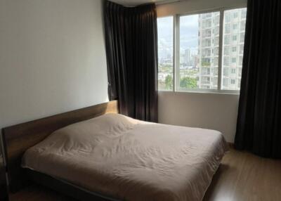 Bedroom with bed, window, and curtains