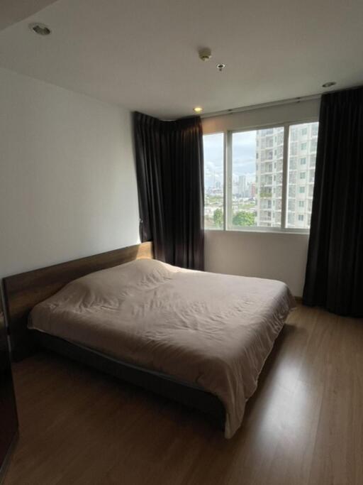 Bedroom with bed, window, and curtains