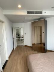 Modern bedroom with wooden flooring and mirrored wardrobe doors