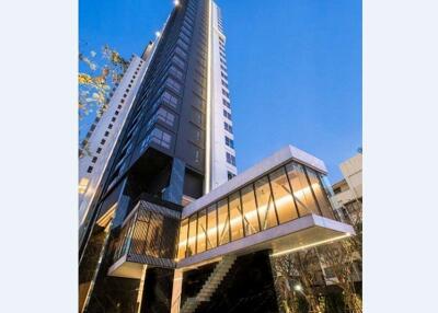 Modern high-rise building with glass facade and evening lights