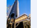 Modern high-rise building with glass facade and evening lights