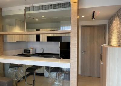 Modern kitchen with bar counter and wooden cabinetry