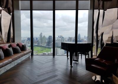 Living room with a panoramic city view and a grand piano