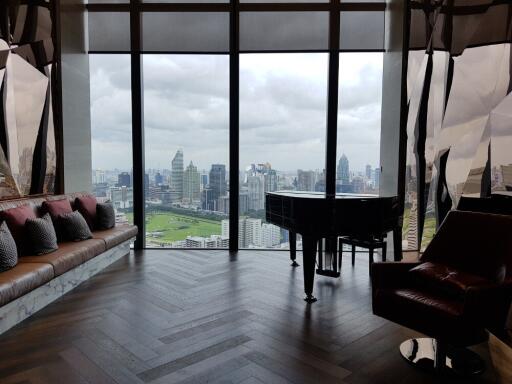 Living room with a panoramic city view and a grand piano