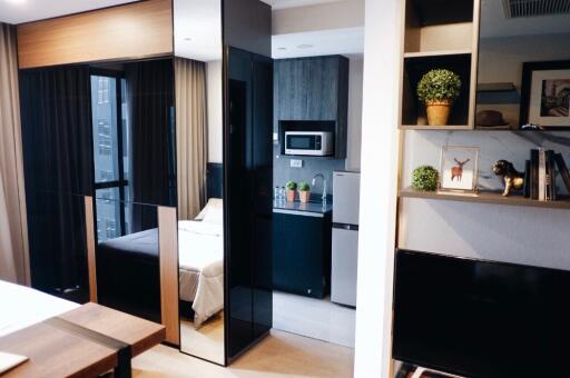 Modern studio apartment with a bedroom, kitchen, and living area