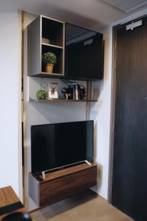 Modern living room corner with TV and shelving