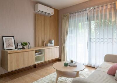 A cozy living room with modern furniture and natural light.