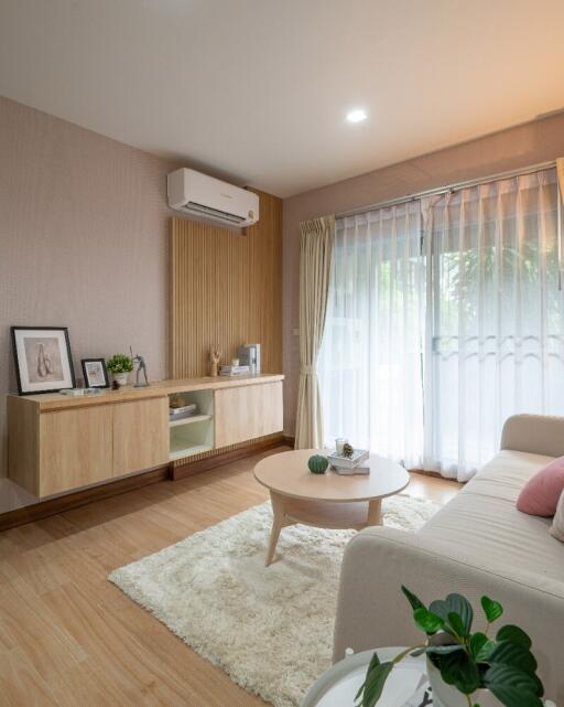 A cozy living room with modern furniture and natural light.