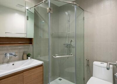 Modern bathroom with glass shower and wooden vanity