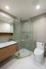 Modern bathroom with glass shower and wooden vanity