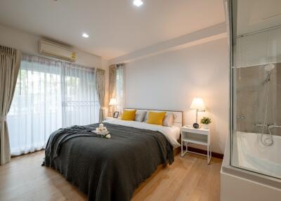 Well-lit bedroom with large windows and modern decor