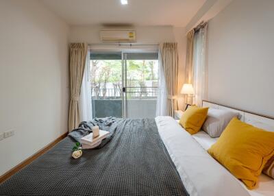 Cozy bedroom with large window and balcony view