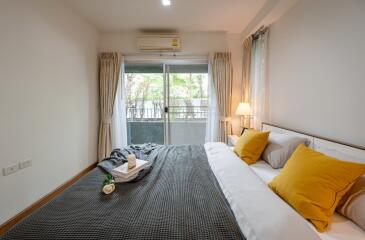 Cozy bedroom with large window and balcony view