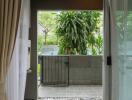 Open balcony view through sliding glass door with garden