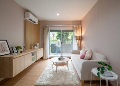 Modern living room with sofa, coffee table, and air conditioner