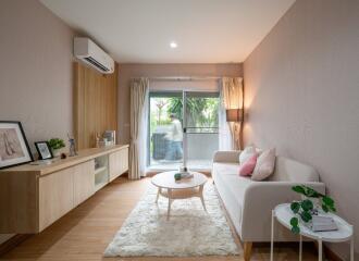 Modern living room with sofa, coffee table, and air conditioner