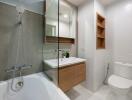 Modern bathroom with bathtub, sink, and toilet