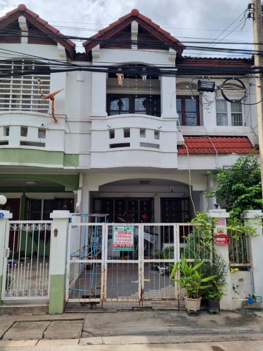 Front view of a residential building with a gated entrance