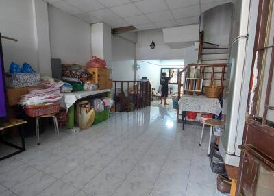 Spacious living area with tiled floor and staircase