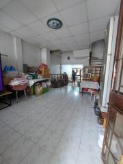 Spacious living area with tiled floor and staircase