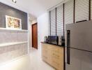 Modern kitchen with fridge, microwave, and storage