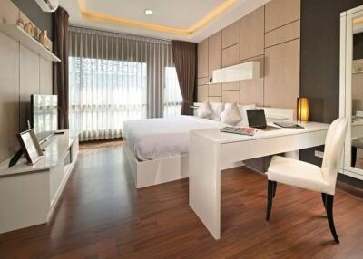 Modern bedroom with wooden flooring and contemporary furnishings