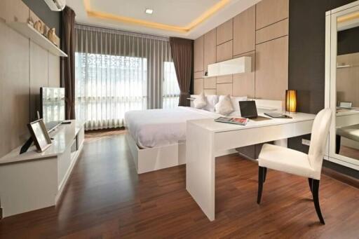 Modern bedroom with wooden flooring and contemporary furnishings