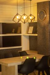 Modern dining area with pendant lights and wall shelves