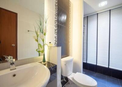 Modern bathroom with sink, toilet, and glass door shower