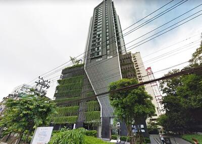 Modern high-rise residential building with greenery