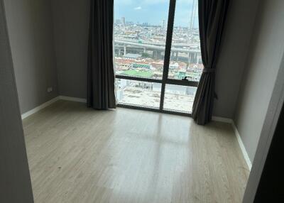 Bedroom with a large window and city view