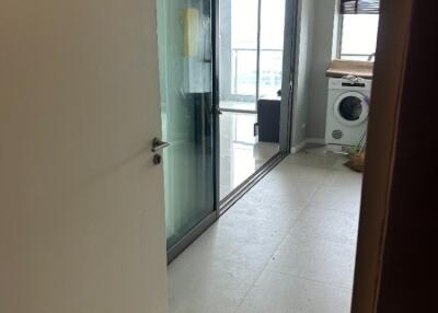 Laundry area with glass doors and washing machine