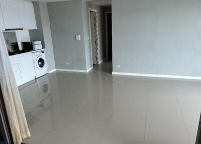 Modern open-plan main living area with kitchen and laundry facilities