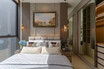 Modern bedroom with large window, artwork, and built-in wardrobe