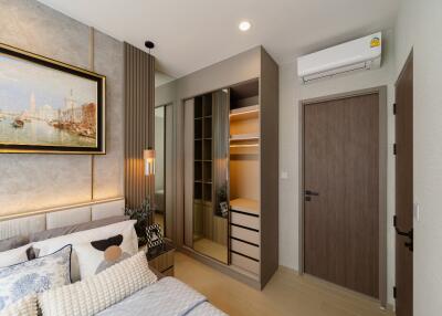 Modern bedroom with contemporary decor, large wardrobe, and air conditioning