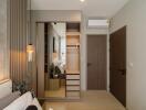 Stylish bedroom with a wardrobe, door, and AC unit