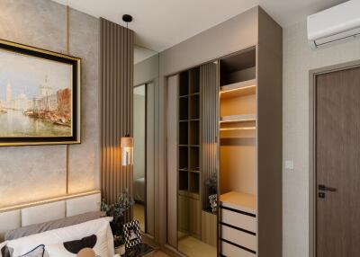 Modern bedroom with built-in wardrobe and artwork