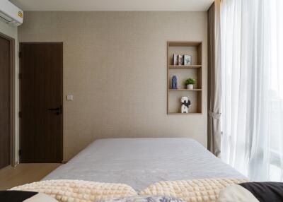 Modern bedroom with bed, shelves, and large window