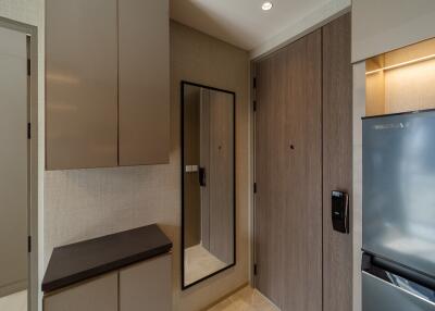 entryway with mirror and cabinets