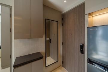 entryway with mirror and cabinets