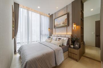 Modern styled bedroom with large windows and elegant furnishings