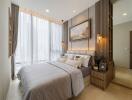 Modern styled bedroom with large windows and elegant furnishings