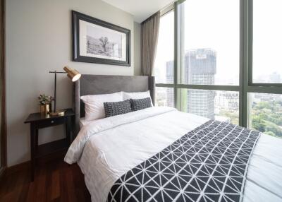 Modern bedroom with a large window and a city view