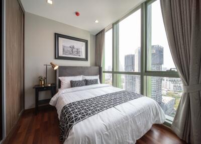 Modern bedroom with a large window and city view