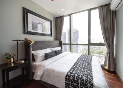 modern bedroom with large window and city view