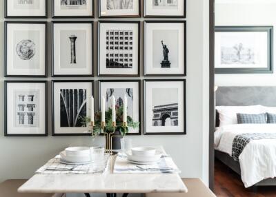 Dining area with wall art and view into the bedroom