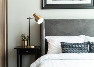 Modern bedroom with stylish lamp and framed picture