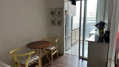 Small dining area with table and two chairs adjacent to modern kitchen